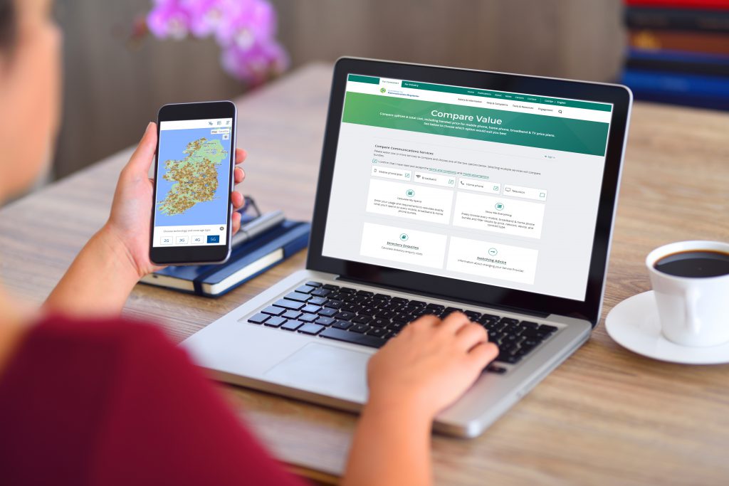 Person checking ComReg Outdoor Mobile Coverage Map on a smart phone and checking ComReg Compare comparison tool on a laptop.